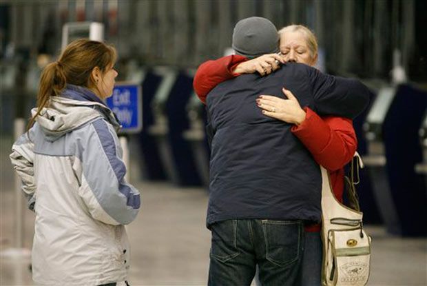 Family members comfort each other at Buffalo's airport